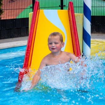 zwembad jongen van glijbaan.jpg